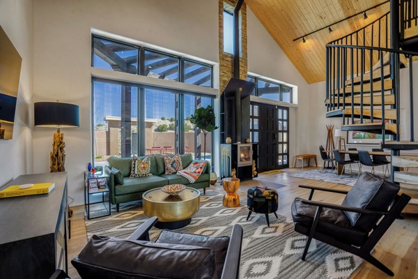 Unwind in your stylish living space with soaring ceilings, cozy fireplace, and vibrant Southwest décor that creates the perfect retreat.