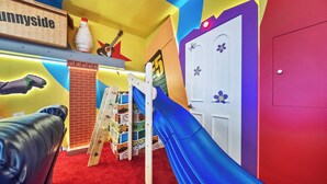 A children's play area with a slide, climbing wall, and a red carpet. - 10BR house sleeps 26 with private pool (Clermont)