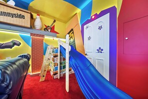 A children's play area with a slide, climbing wall, and a red carpet. - 10BR house sleeps 26 with private pool (Clermont)