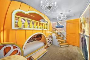 A room with a curved wall design, a staircase, and a chandelier. - 10BR house sleeps 26 with private pool (Clermont)