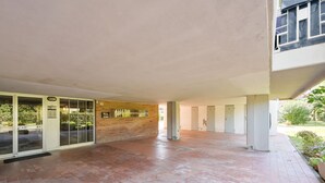 A spacious indoor area with a tiled floor, a glass door entrance, and a brick wall. - Comfortable 75 sqm apartment, accommodating up to 6 people, located on the second floor of a building without an elevator.The property is located in Luni Mare, in a well-served residential area. The location is convenient, a short distance from the sea a (Luni)
