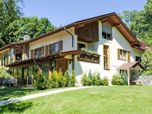 A two-story house with a balcony, large windows, and a stone chimney. - Apartment Luna by Interhome (Feldkirchen in Kärnten)