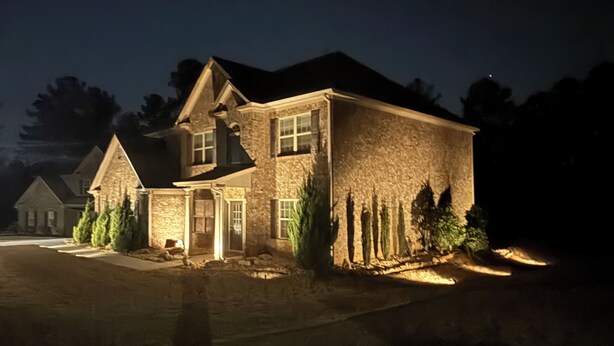 A two-story house with a stone facade, a front porch, and a driveway. - World Cup Ready Spacious 5BR Home Near Atlanta Stadium & Downtown Restaurants (Fairburn)