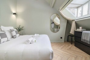 A neatly arranged bedroom with a bed, a bedside table, a dresser, a mirror, and a window with curtains. - Nice apartment 1BDR/4PAX in Opera (Paris)