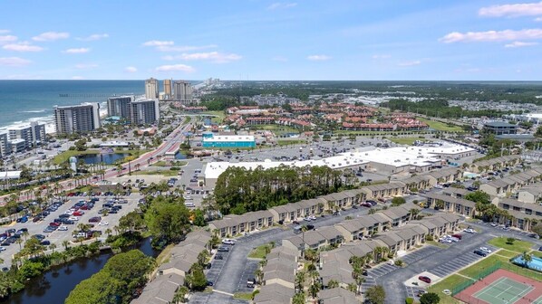 A coastal cityscape with a marina, high-rise buildings, and a large parking lot. - Gulf Highlands 2BR 11 Pools Beach Access Sleeps 6 (Panama City Beach)