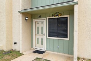 A building entrance with a numbered door, a mailbox, and a small outdoor light fixture. - Gulf Highlands 2BR 11 Pools Beach Access Sleeps 6 (Panama City Beach)