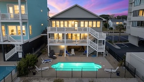 A two-story building with a balcony, a swimming pool, and a parking area. - Phenomenal On Ocean Central Huge 4k sqft w Private Pool/Yard/Patio/Deck/Gameroom (North Myrtle Beach)