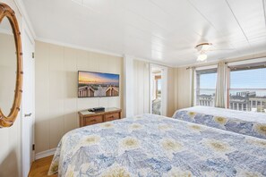 A hotel room with two beds, a TV, a wooden dresser, a painting, and a balcony with a view. - Phenomenal On Ocean Central Huge 4k sqft w Private Pool/Yard/Patio/Deck/Gameroom (North Myrtle Beach)