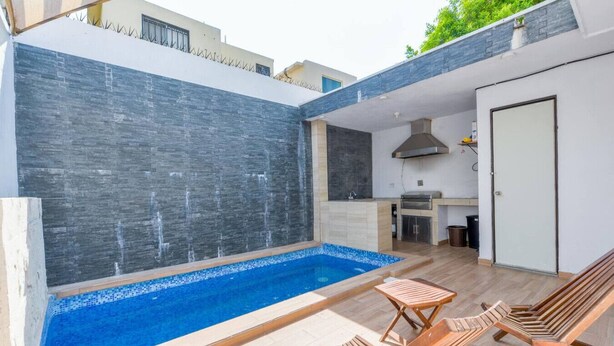 A modern outdoor pool area with a built-in kitchen and seating. - 1 King, 3 Twin bed, Pool & 2 parking | 3BR2br 7ppl (Monterrey)
