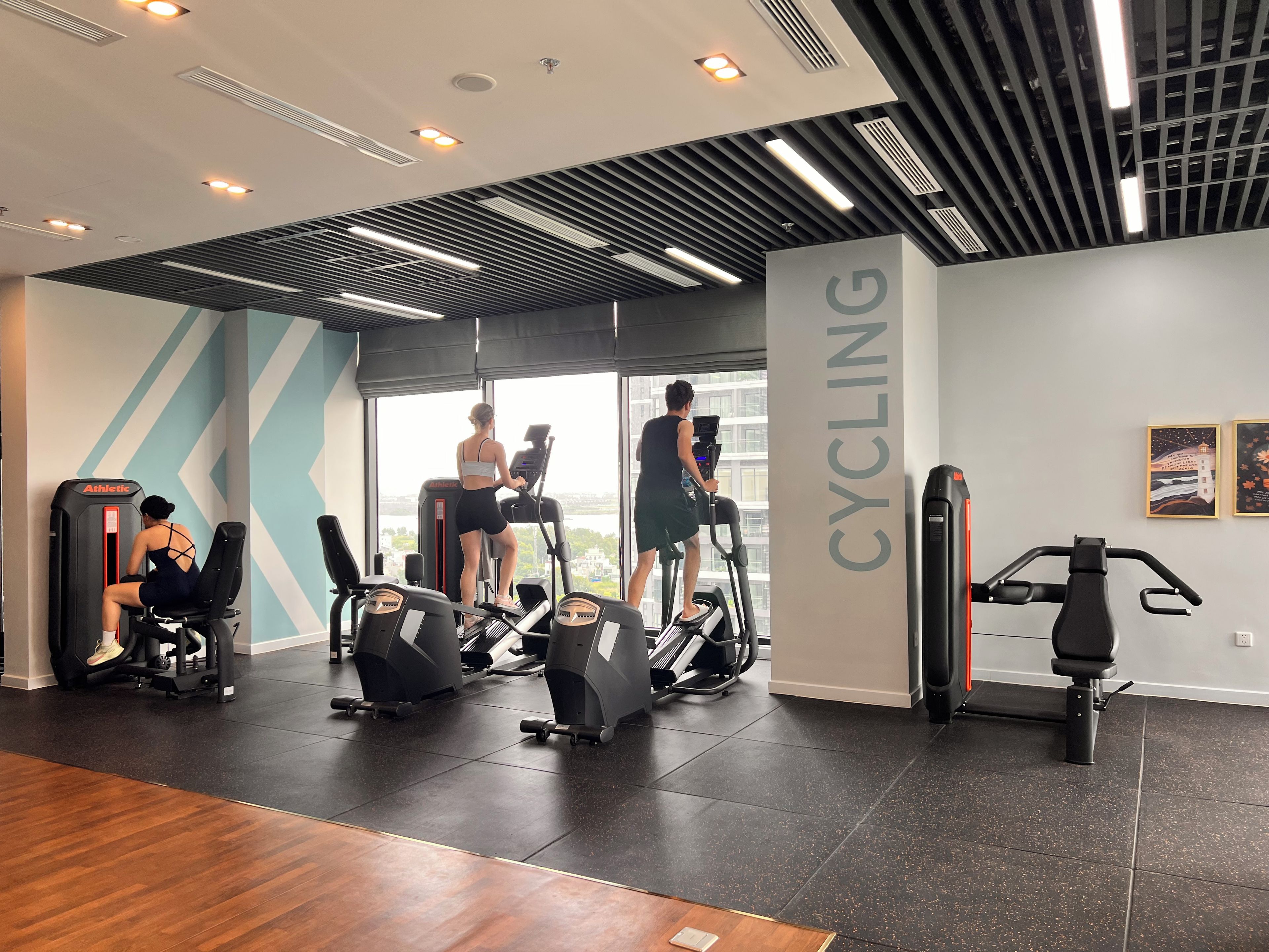 A gym with treadmills, stationary bikes, and weight machines.