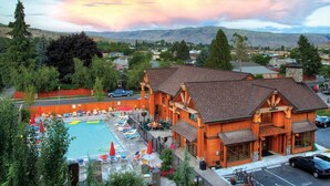 A lodge with a swimming pool, outdoor seating, and a view of the surrounding landscape. - Lake Ozarks | Family Lake Retreat | Pool + Lake | 3BR Sleeps 8 (Chelan)