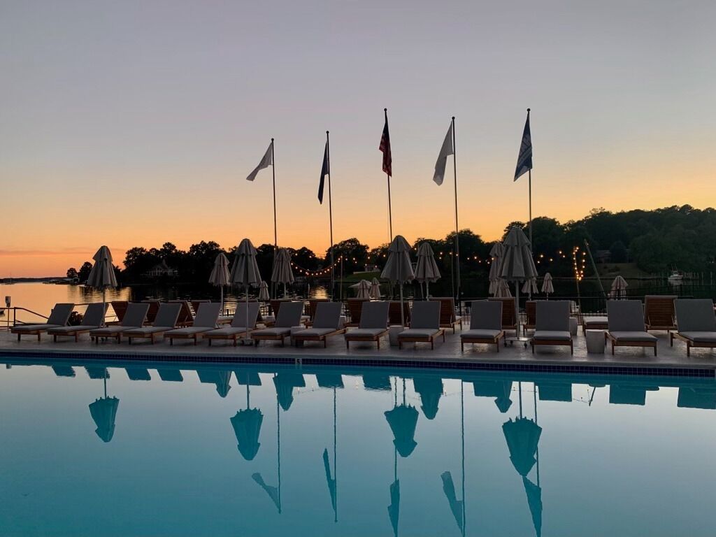 Unwind at sunset as the pool mirrors a glowing sky.