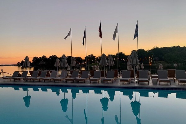 Unwind at sunset as the pool mirrors a glowing sky.