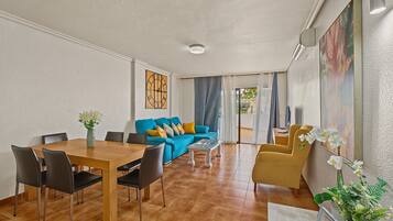 Una sala de estar moderna con comedor, un juego de sofá y una mesa de centro.