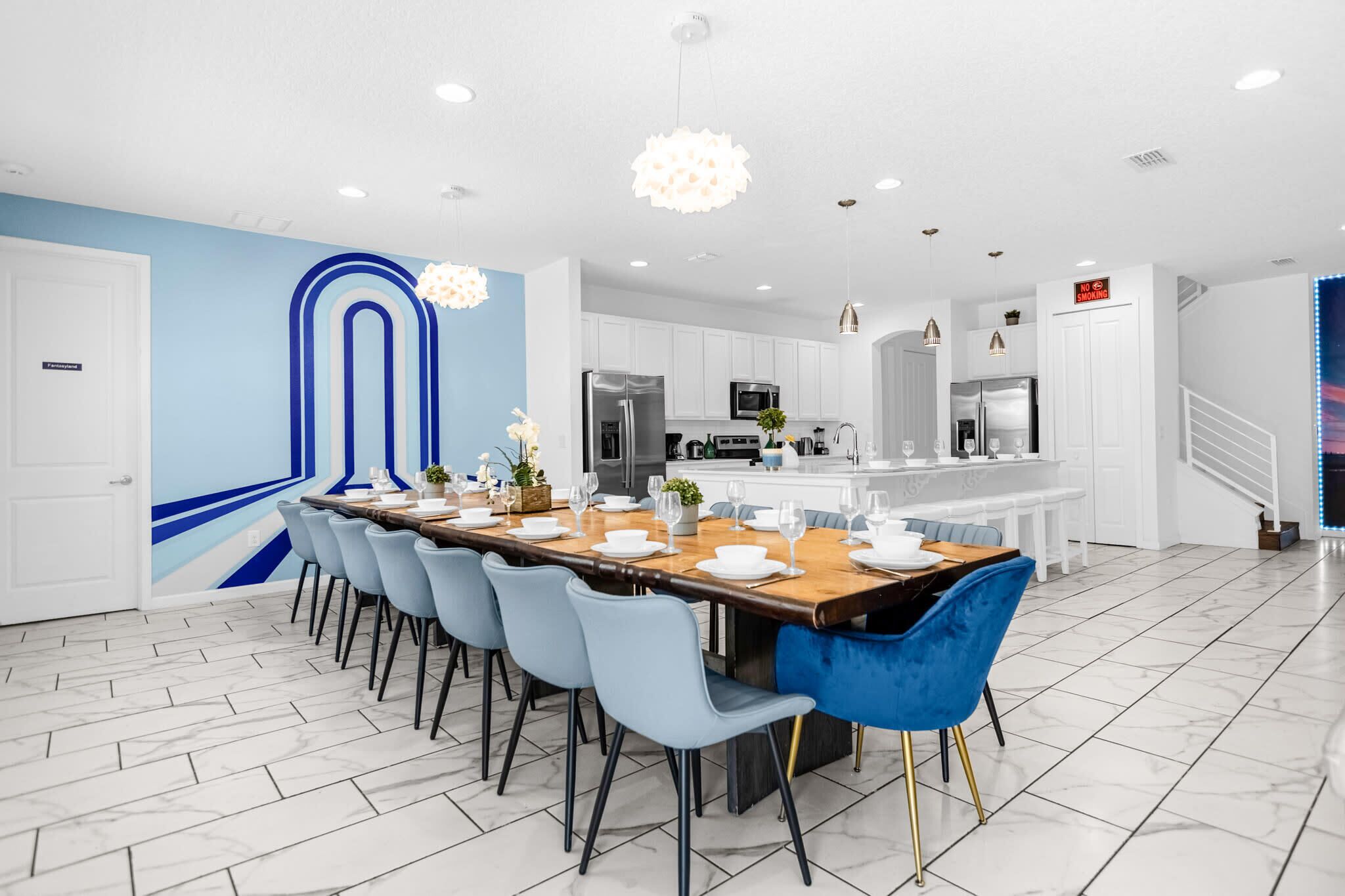 A modern kitchen with white cabinets, stainless steel appliances, and a central island.