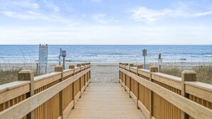 A wooden boardwalk leading to a beach with clear skies. - Perfect Peace:Spacious 1 BR King, Walk-in Shower, Big Balcony, Undeveloped Beach (Myrtle Beach)