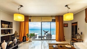 A modern living room with a large window, a telescope, and a view of the sea. - Elegant Nian Villa Sea - Luxury Stay in Drosia, Chalkida (Chalkida)