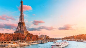The Eiffel Tower, a river, and a bridge in Paris.