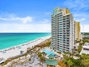 A high-rise hotel with a pool, beach access, and a view of the ocean. - Stunning Gulf View and Beach Front Coastal Escape (Miramar Beach)