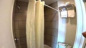A bathroom with a bathtub, toilet, and towel rack. - GG Rest Inn (Elizabeth)