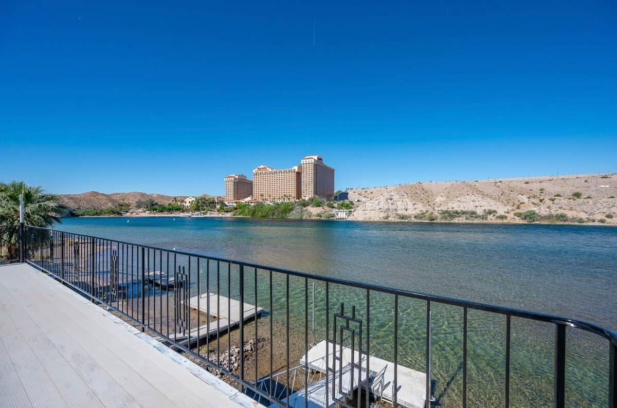 A river with a clear view of a hotel complex in the background.