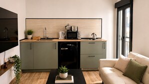 A modern kitchen with a dishwasher, microwave, kettle, and coffee maker. - Collection Las Ventas Apartamento G Cerca de la Plaza de Toros (Madrid)