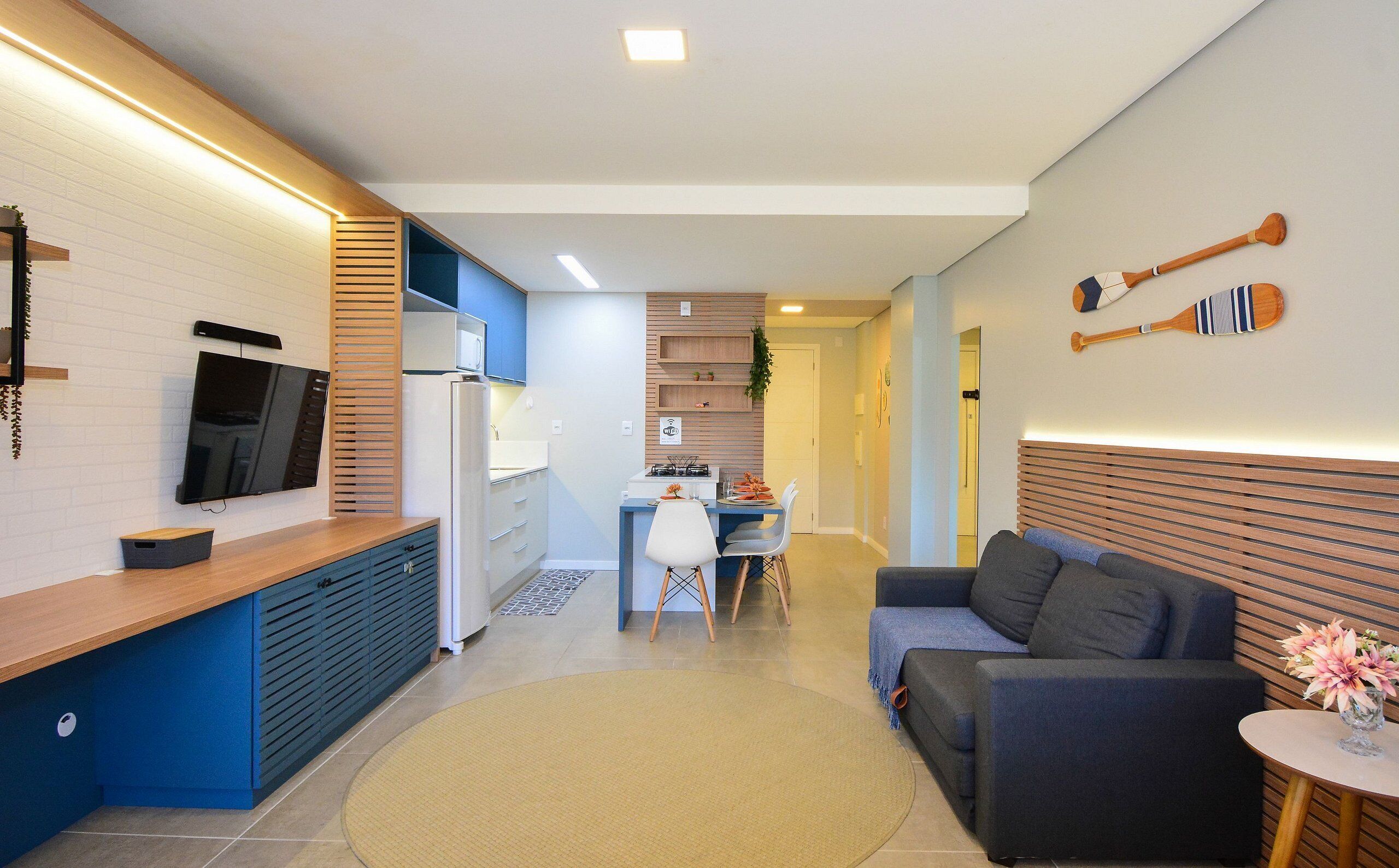 A modern living space with a kitchen, dining area, and seating area.