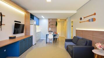 A modern living space with a kitchen, dining area, and seating area.