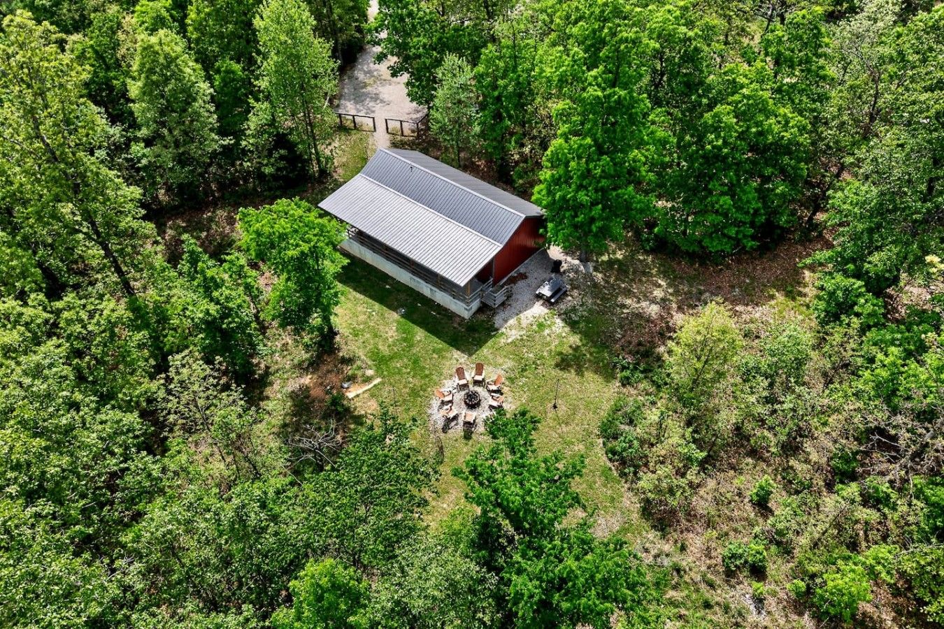 A single-story building with a flat roof, surrounded by dense green forest.