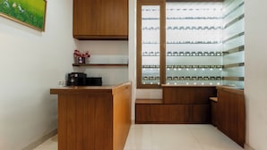 A modern kitchen with wooden cabinets, a countertop, and a built-in refrigerator. - Colletion O near Living Plaza Cirebon fo (West Cirebon)