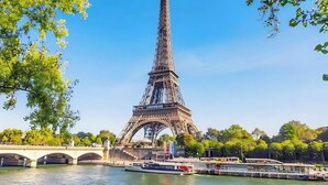 The Eiffel Tower with a river and bridge in the foreground. - TheBlueStay 272 - Stunning Apartment in Paris 6 (Paris)
