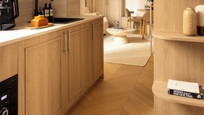 A modern kitchen with wooden cabinets, a black faucet, and a coffee machine. - Modern Apartment a/c 1ch/4p - Saint -germain (Paris)