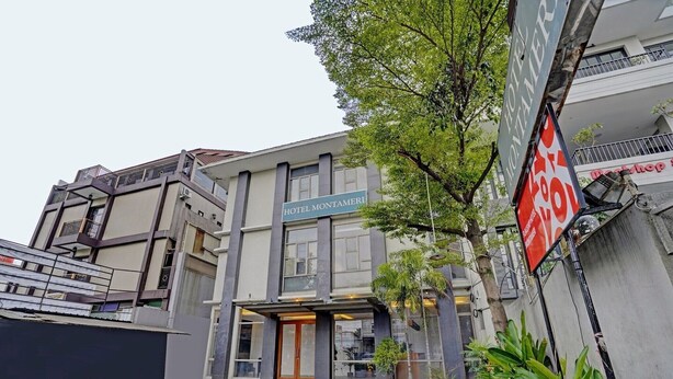 A hotel with a modern facade, a visible entrance, and a sign indicating it is a hotel. - Luxury Deluxe DBL Retreat W/ Free WiFi and Parking (Bandung)