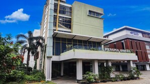A hotel with a modern design, featuring a prominent entrance, large windows, and a sign reading 'RESONA HOTEL.'