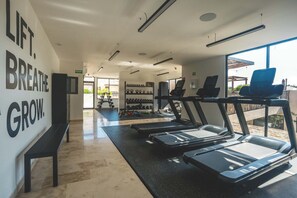A gym with treadmills, weights, and a motivational wall. - Luxury 2BR Retreat with Private Pool & Spa (Tulum)