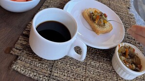 A breakfast table with various food items, a glass of orange juice, and a cup of coffee. - Urra Village Pousada Atins (Atins)