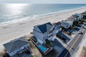 A residential area with houses near a beach, a swimming pool, and a road. - Ocean Front Pool+HotTub+Elevator 9Bedroom8Bathroom (Surf City)