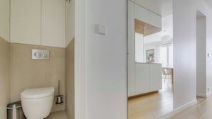 A modern bathroom with a toilet, bidet, and trash can. - Beautiful Apartment - 1br- 4P - Sacre-coeur (Paris)