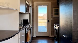 A modern kitchen with a built-in oven, microwave, and a coffee machine. - New Listing. A short walk to the beach. (Provincetown)