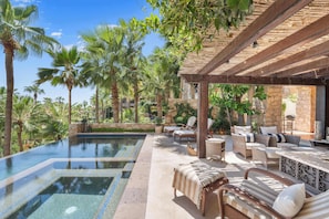 A poolside area with lounge chairs, a pergola, and palm trees. - Hacienda Beach Club Villa w/ Private Pool! (Hacienda Beach Club & Residences)