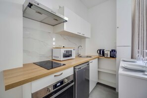 A compact kitchen with a microwave, toaster, and dishwasher. - Modern Apartment 1br/4p - Levallois (Levallois-Perret)