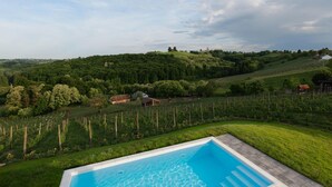 A swimming pool with a view of a vineyard and rolling hills. - Amazing home in Banfi (Banfi)