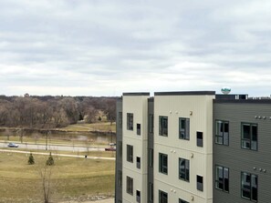 A multi-story building with a flat roof and a water tower on top.