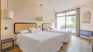 A hotel room with two beds, a large window, and a wall-mounted radiator. - Spacious Apartment - 2br/10p - Place D'italie (Paris)