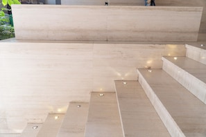 A set of beige stone steps leading up to a flat, light-colored platform. - Cute, modern apartment • 24/7 Doorman Safe + Secure • Walk everywhere (Ciudad de México)