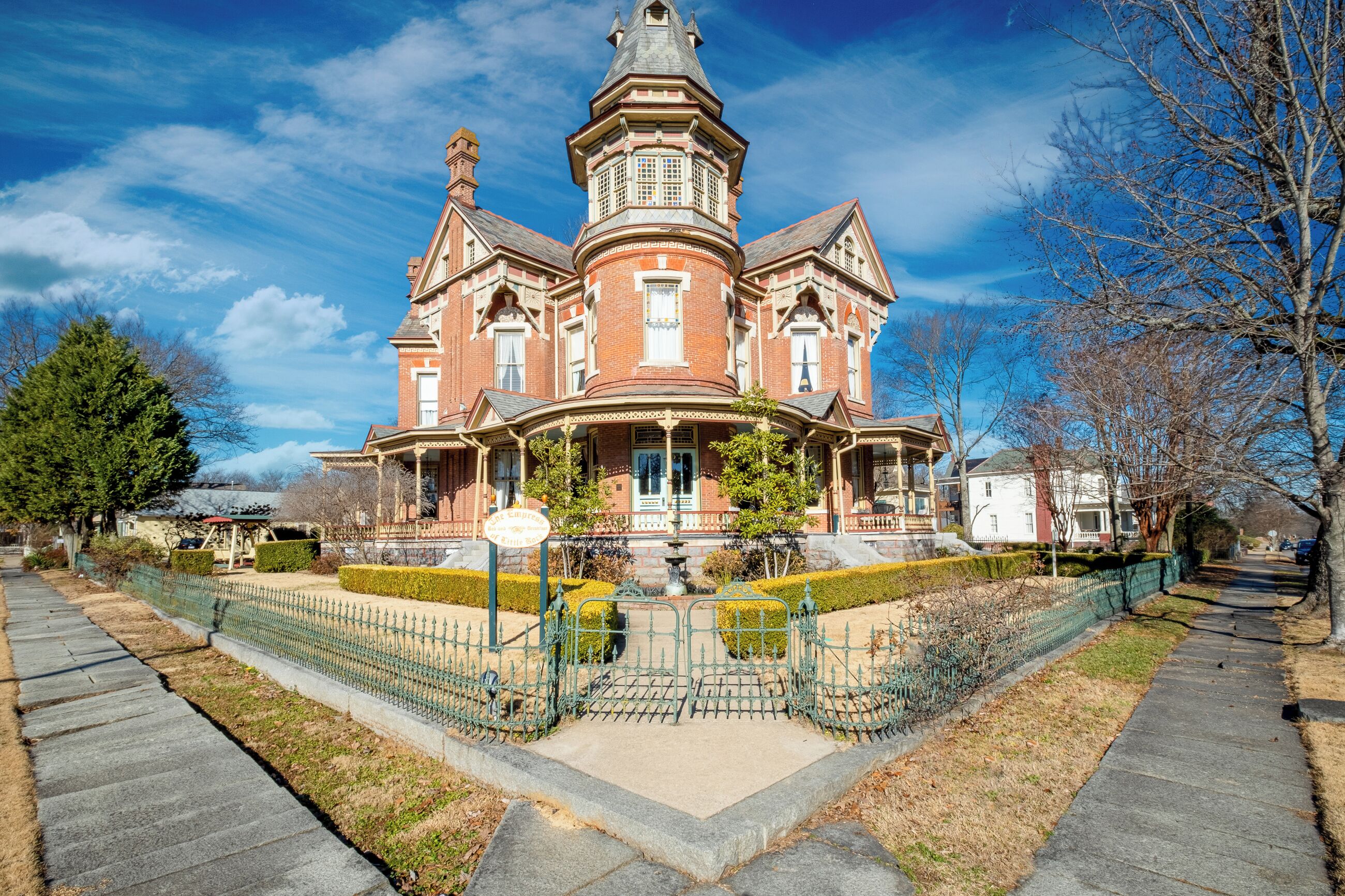 A large, historic brick building with a prominent tower and multiple windows.