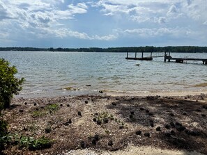 A lake with a dock extending into the water, surrounded by a rocky shoreline with sparse vegetation. - Gilbert Get Away with private dock, boat ramp and gorgeous views (Gilbert)