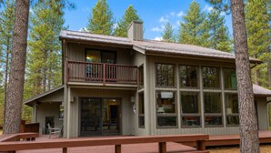 A two-story lodge with a balcony, large windows, and a wooden deck. - Black Butte Ranch Retreat • 3BR+loft & AC • Walk to Glaze Meadow (Sisters)