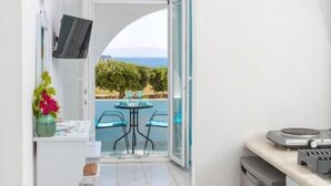A modern kitchen with a built-in oven, a sink, and a countertop with a coffee machine. - Villa Zeta (Paros)