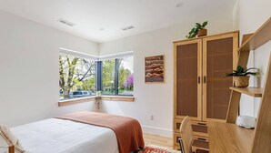 A bedroom with a bed, a window, a wardrobe, and a desk. - New & Modern- 2 Full Kitchens, Sauna, Sleeps 10 (Salt Lake City)